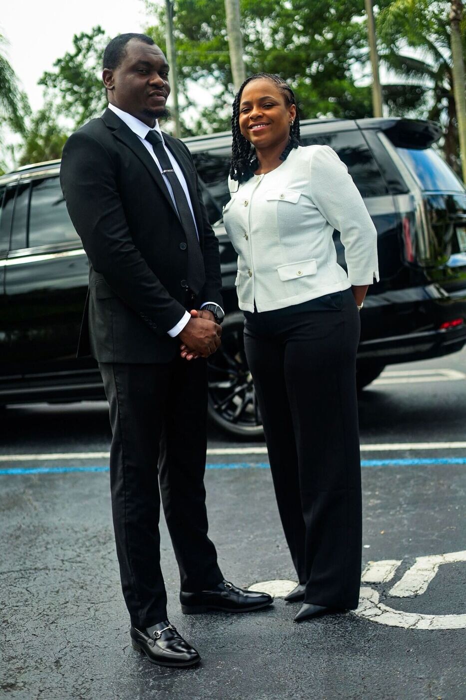 MS Luxury Black Car owner and female chauffeur in front of a black Cadillac Escalade